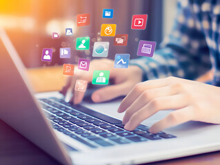Digital Marketer Engaging with Laptop Featuring Floating App Icons, Illustrating Online Social Media Marketing and Virtual Web Design Concepts
