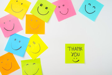 Thank you and smile icon inspirational handwriting on sticky notes on hand held
