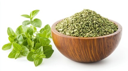 A wooden bowl filled with dried oregano flakes, accompanied by fresh oregano leaves, beautifully arranged and isolated on a white background.