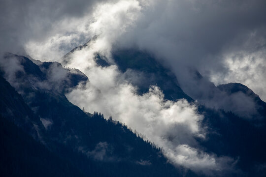 USA, Alaska, Tracy Arm-Fords Terror Wilderness, Morning sun lights mist swirling in mountains above Holkham Bay
