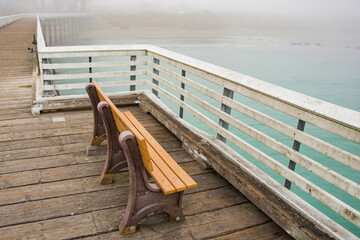 USA, California. San Simeon, empty bench on wharf.