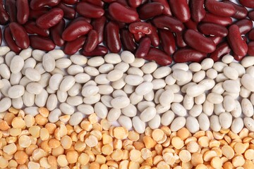 Different types of legumes as background, top view