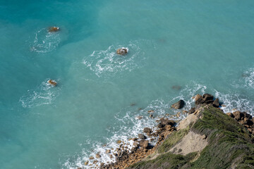 Rocks in the water on the coastline on the Island of Corfu in Greece.