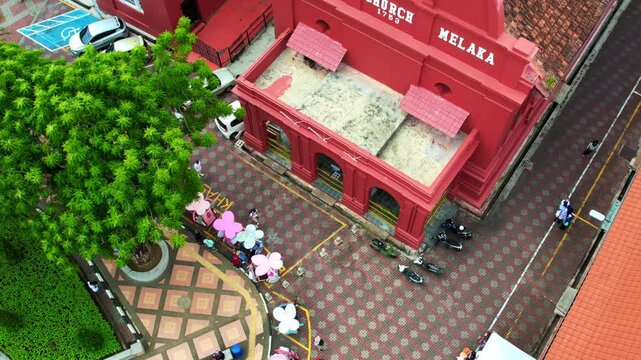 Melaka, Malaysia - July 6, 2023 Pan-up aerial view of the oriental red building in Dutch Square, Malacca. 4K slow-motion