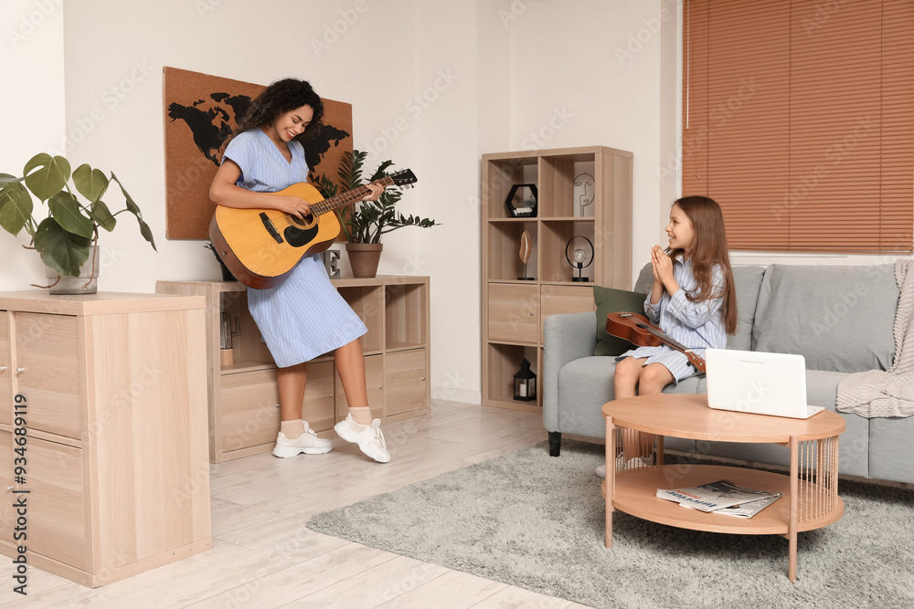 Sticker Young woman and girl playing acoustic guitars at home