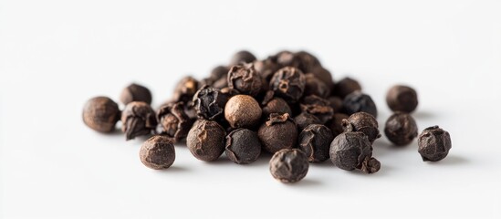 Obraz premium Black Peppercorns on White Background