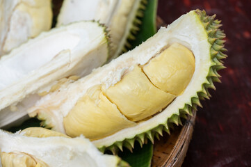 Close up of an opened durians arranging on wooden tray. Durian is a delicious tropical fruit native...