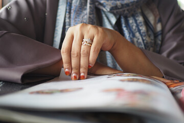 women hand reading a food menu at cafe.