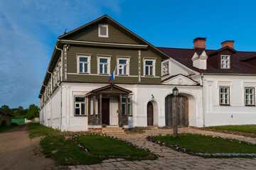 View of historical merchant buildings of estates on the main street of Izborsk Pechorskaya Street on a summer sunny day, Izborsk, Pskov region, Russia
