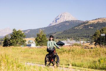 Woman Cycling in Scenic Crowsnest Pass Alberta Landscape