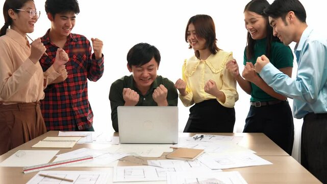 Architect and safety engineer celebrate success design building blueprint project on laptop with architectural document and measurement tool scatter around at modern office. Closeup. Delineation.