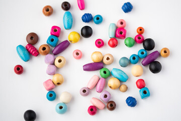 Colorful wooden beads on a white background