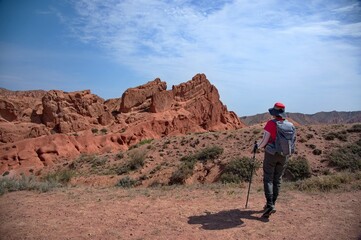 Senior woman hiking in Skazka canyon in Kyrgyzstan