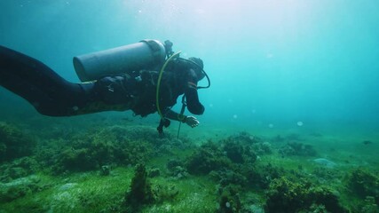 Team of equipped drivers explores hilly ocean floor 