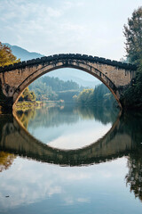 Ancient stone bridge over a calm river