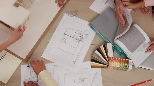 Slow motion interior designer drafting blueprint with customer supervise and oversee interior designer draw house room layout on home based on client demand. Architectural customer service. Variegated