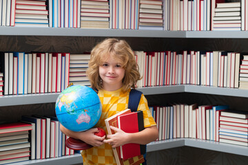 School boy with world globe and books. School and education concept. Portrait of cute child school boy. Back to school.