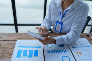 woman meticulously plans a finance audit, using a computer and calculator to review budget...