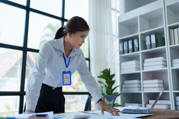 woman plans a finance and budget audit by reviewing organizing office financial documents