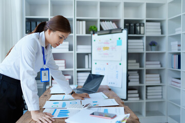woman plans a finance and budget audit by reviewing organizing office financial documents