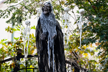 Halloween Skeletons, pumpkins and skulls. Halloween pumpkin and skeleton for decorated house. Scary Decorated at front yard of a Halloween house. Trick or treat. Halloween background.