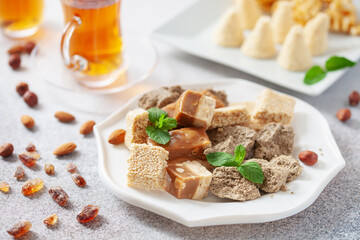 Oriental sweetness.  Nougat, halva and  tea on a table.