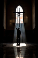 A man is standing in a church with a cross in front of him. He is holding his hands up in the air