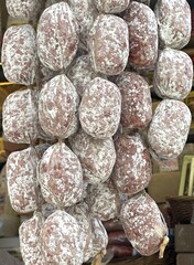 Smoked sausages hanging on deli display