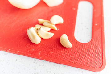garlic cloves on a red chopping board in the Kitchen