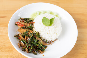 Thai Cuisine: Fried Rice with Chicken, Basil, and Vegetables on a Plate, Highlighting the Flavors of Local Asian Herbs and Food