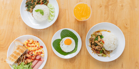Top View of a Thai Rice Dish: Local Cuisine on a Wooden Table, Featuring Vegetables and a Stylish Platter, Perfect for Savoring a Home-Cooked Meal or Restaurant Experience