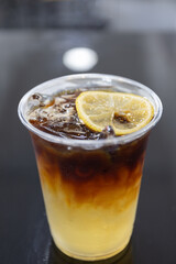 Perfect Summer Refreshment: Iced Coffee with Lemon Garnish, Served in a Cup, Enjoyed in the Sunshine