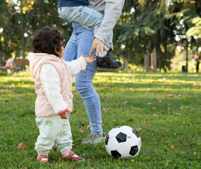 Low angle view of unrecognizable mother with her kids in a park