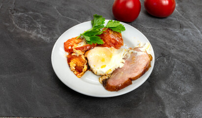 Fried Egg with Tomatoes and Bacon on a Plate