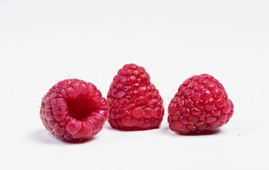 three red ripe raspberries composition isolated on white background, ingredients for baking