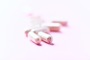 Collagen capsules. Bright paper background. Soft focus. Close up. Copy space.