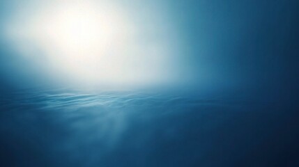 Obraz premium Celestial Dawn: ethereal glow of the rising sun illuminates a tranquil sea of clouds, casting a serene blue hue across the vast expanse. 