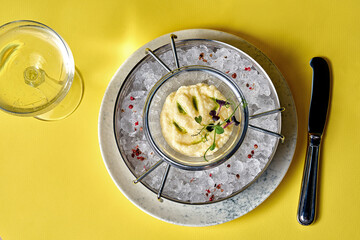 A luxurious and elegant presentation of pike caviar served on ice with a glass of champagne