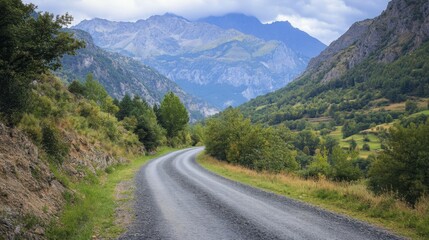 photo of a narrow asphalt road in a mountainous area.