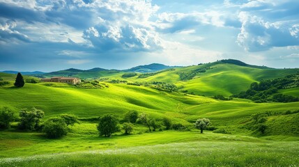Obraz premium Rolling Green Hills with a Farmhouse and Blue Sky