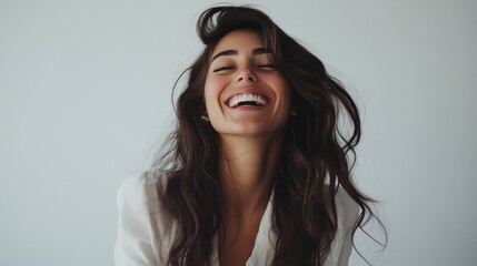 Laughter in focus, dark-haired woman enjoying moment.