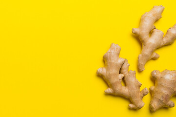 Finely dry Ginger powder in bowl with green leaves isolated on colored background. top view flat lay