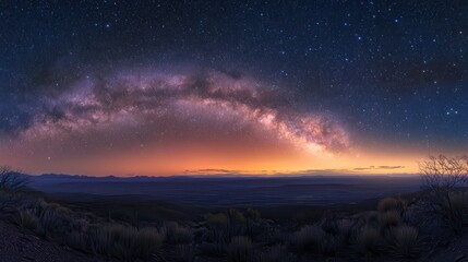 A stunning panoramic view of the Milky Way galaxy over a serene landscape at dusk.