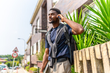 African young businessman talking to the mobile in the city