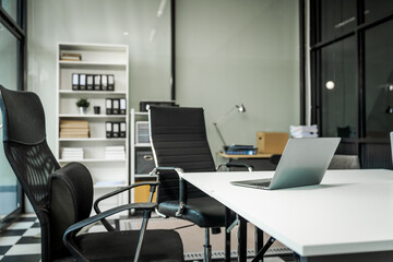 A modern office desk with a laptop, monitor, and plant. sleek, minimal design features open space, technology and productivity. room is empty, offering a clean and organized workspace.