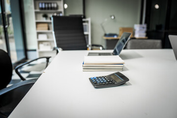 A modern office desk with a laptop, monitor, and plant. sleek, minimal design features open space, technology and productivity. room is empty, offering a clean and organized workspace.