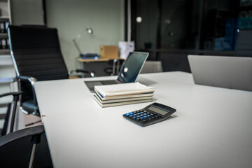 A modern office desk with a laptop, monitor, and plant. sleek, minimal design features open space, technology and productivity. room is empty, offering a clean and organized workspace.