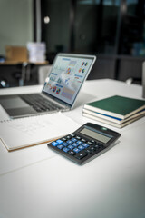 A modern office desk with a laptop, monitor, and plant. sleek, minimal design features open space, technology and productivity. room is empty, offering a clean and organized workspace.