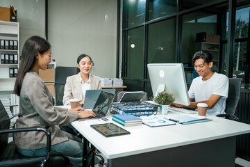 Asian colleagues meet at a desk, discussing business financial terms, investment strategies, managing funds. Their focus is on planning, analysis, and operations to ensure stability and success.
