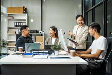 Asian colleagues meet at a desk, discussing business financial terms, investment strategies,...
